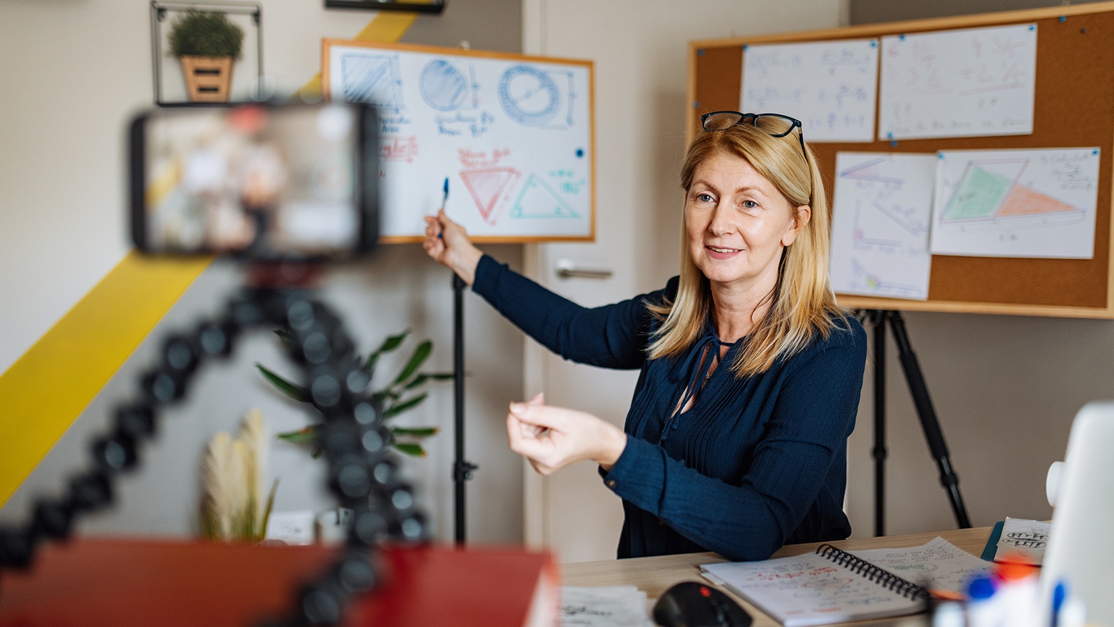 Mature smart professor holding online class for e-learning school kids and students