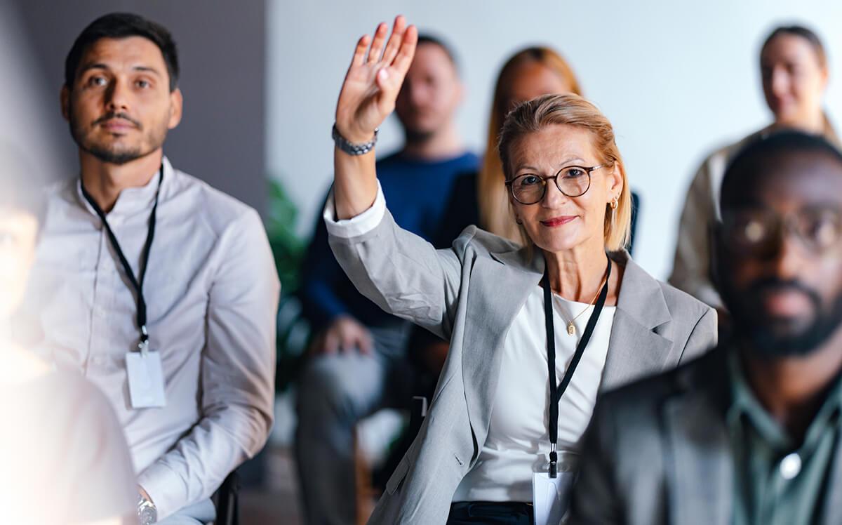 confident businesswoman raising hand