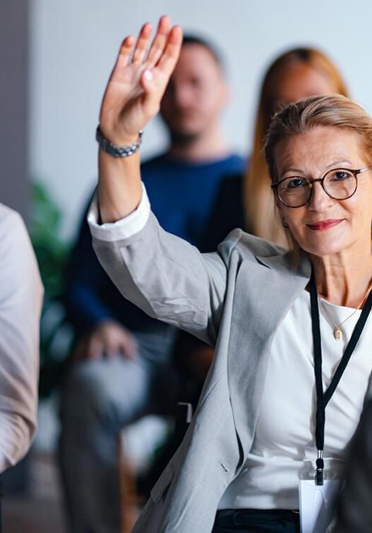 confident businesswoman raising hand