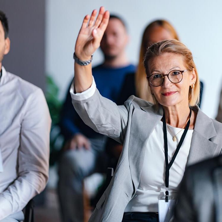 confident businesswoman raising hand